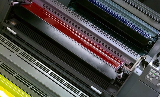 Cyan, magenta, and yellow ink rollers on a printing press